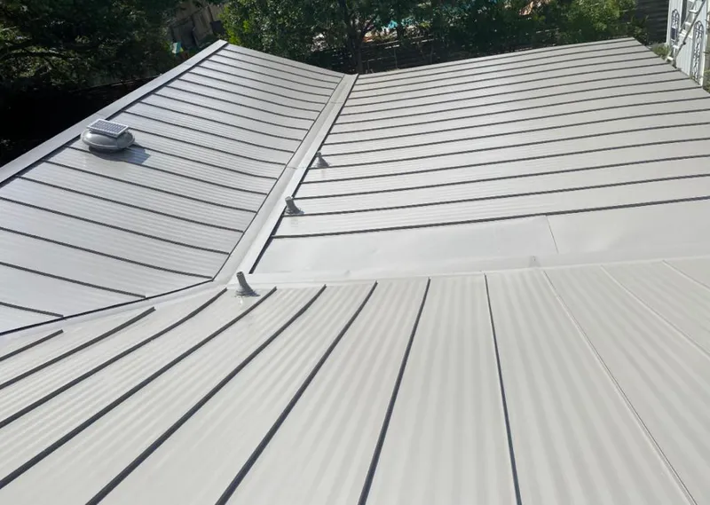 Solar attic fan installed on a metal roof for Roof Ventilation in Massapequa Park